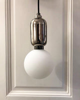 modern-spherical-glass-pendant-light-with-polished-metal-accents-for-luxury-interiors