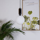 modern-spherical-glass-pendant-light-with-polished-metal-accents-for-luxury-interiors