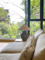 rustic-carved-ceramic-table-lamp-with-white-linen-drum-shade-and-handcrafted-earth-toned-finish