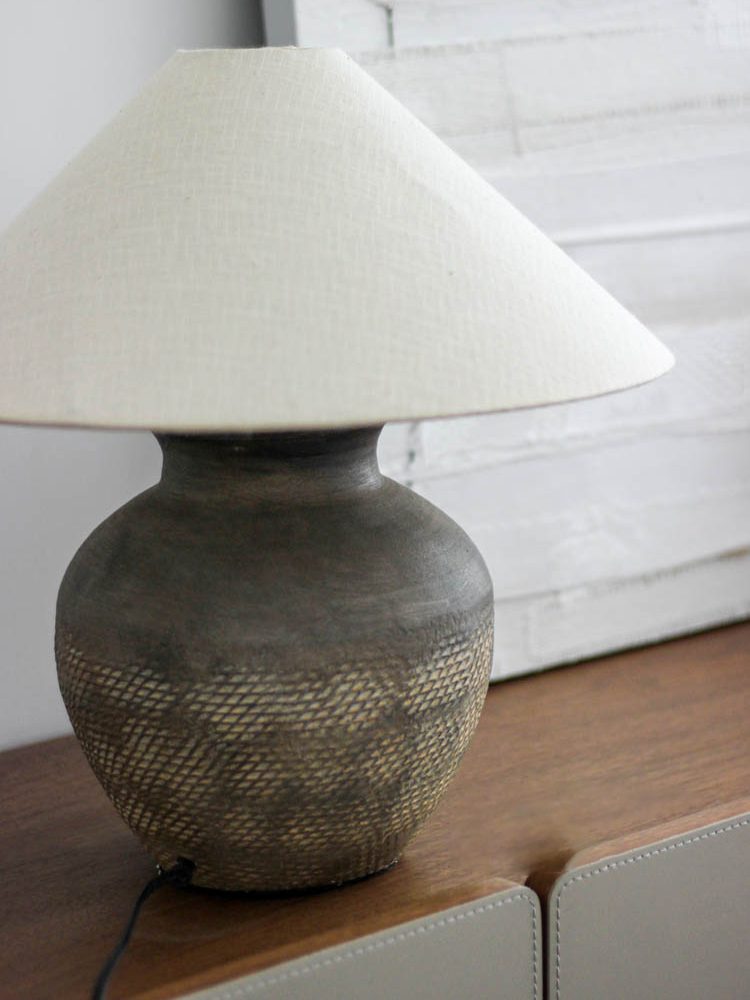 rustic-carved-ceramic-table-lamp-with-white-linen-drum-shade-and-handcrafted-earth-toned-finish