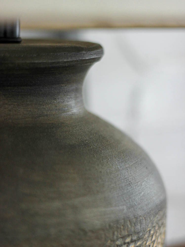 rustic-carved-ceramic-table-lamp-with-white-linen-drum-shade-and-handcrafted-earth-toned-finish