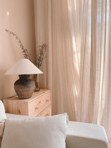 rustic-carved-ceramic-table-lamp-with-white-linen-drum-shade-and-handcrafted-earth-toned-finish