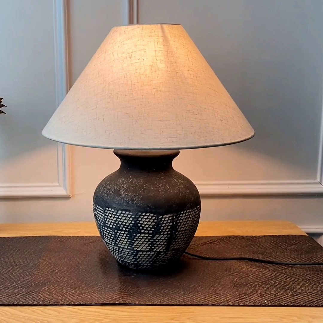 rustic-carved-ceramic-table-lamp-with-white-linen-drum-shade-and-handcrafted-earth-toned-finish