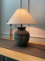 rustic-carved-ceramic-table-lamp-with-white-linen-drum-shade-and-handcrafted-earth-toned-finish