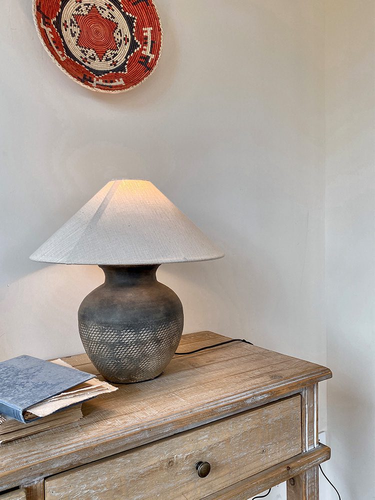 rustic-carved-ceramic-table-lamp-with-white-linen-drum-shade-and-handcrafted-earth-toned-finish
