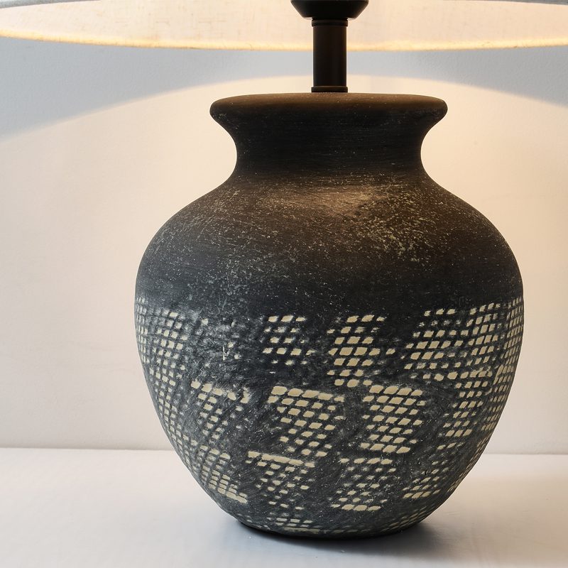 rustic-carved-ceramic-table-lamp-with-white-linen-drum-shade-and-handcrafted-earth-toned-finish
