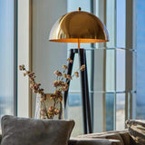 mid-century-modern-tripod-floor-lamp-with-dome-gold-metal-shade-and-black-legs