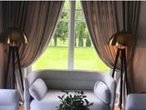 mid-century-modern-tripod-floor-lamp-with-dome-gold-metal-shade-and-black-legs