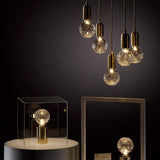 modern-crystal-glass-sphere-table-lamp-with-polished-brass-base-and-warm-led-glow