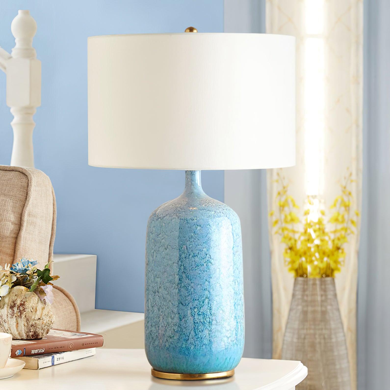 blue-ceramic-table-lamp-with-reactive-glaze-finish-and-white-linen-drum-shade