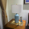 blue-ceramic-table-lamp-with-reactive-glaze-finish-and-white-linen-drum-shade