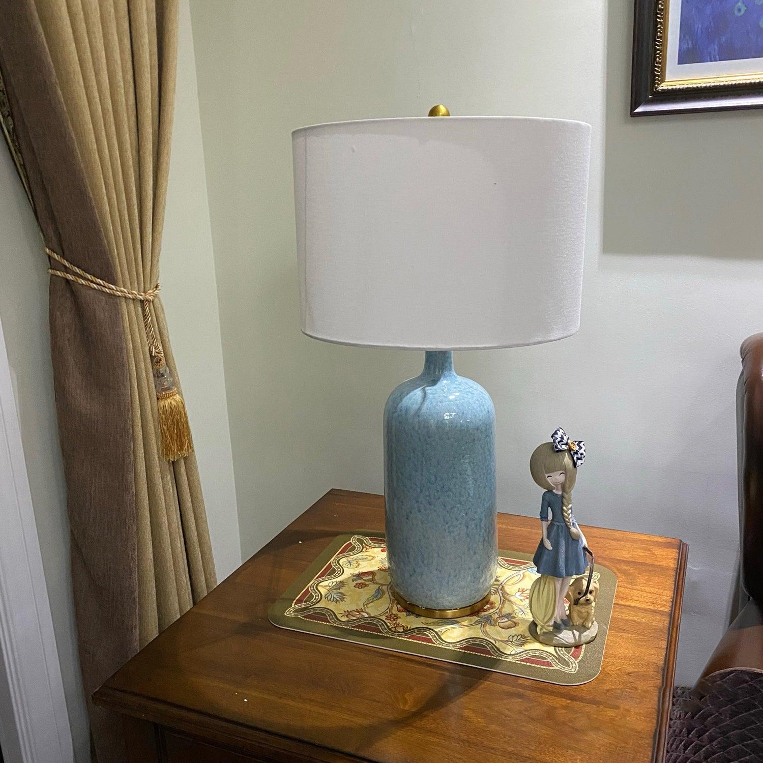 blue-ceramic-table-lamp-with-reactive-glaze-finish-and-white-linen-drum-shade