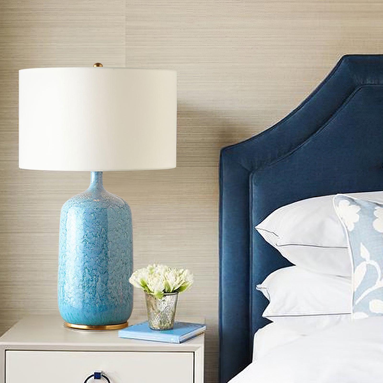 blue-ceramic-table-lamp-with-reactive-glaze-finish-and-white-linen-drum-shade