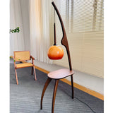 Modern Curved Mantis Wood Floor Lamp with Amber Glass Orb Shade for Living Room and Bedroom