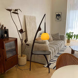 Modern Curved Mantis Wood Floor Lamp with Amber Glass Orb Shade for Living Room and Bedroom