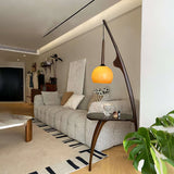 Modern Curved Mantis Wood Floor Lamp with Amber Glass Orb Shade for Living Room and Bedroom