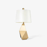 modern-gold-asymmetrical-faceted-table-lamp-with-polyhedral-metal-base-and-fabric-shade