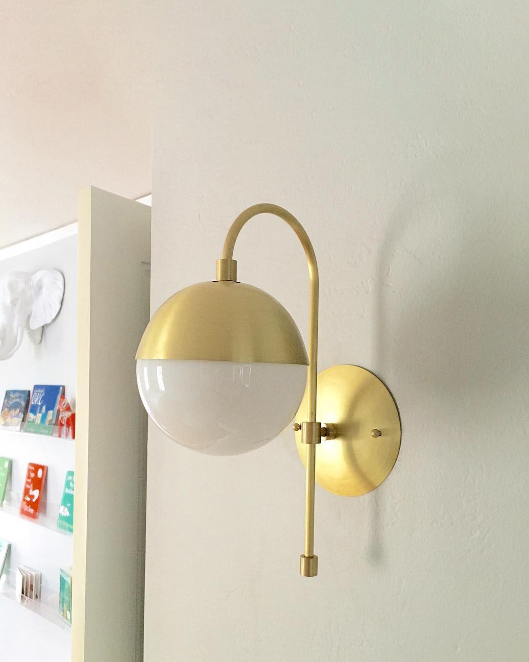 elegant-opaque-glass-globe-wall-sconce-with-brass-finish-modern-indoor-lighting-for-bedrooms-and-living-rooms