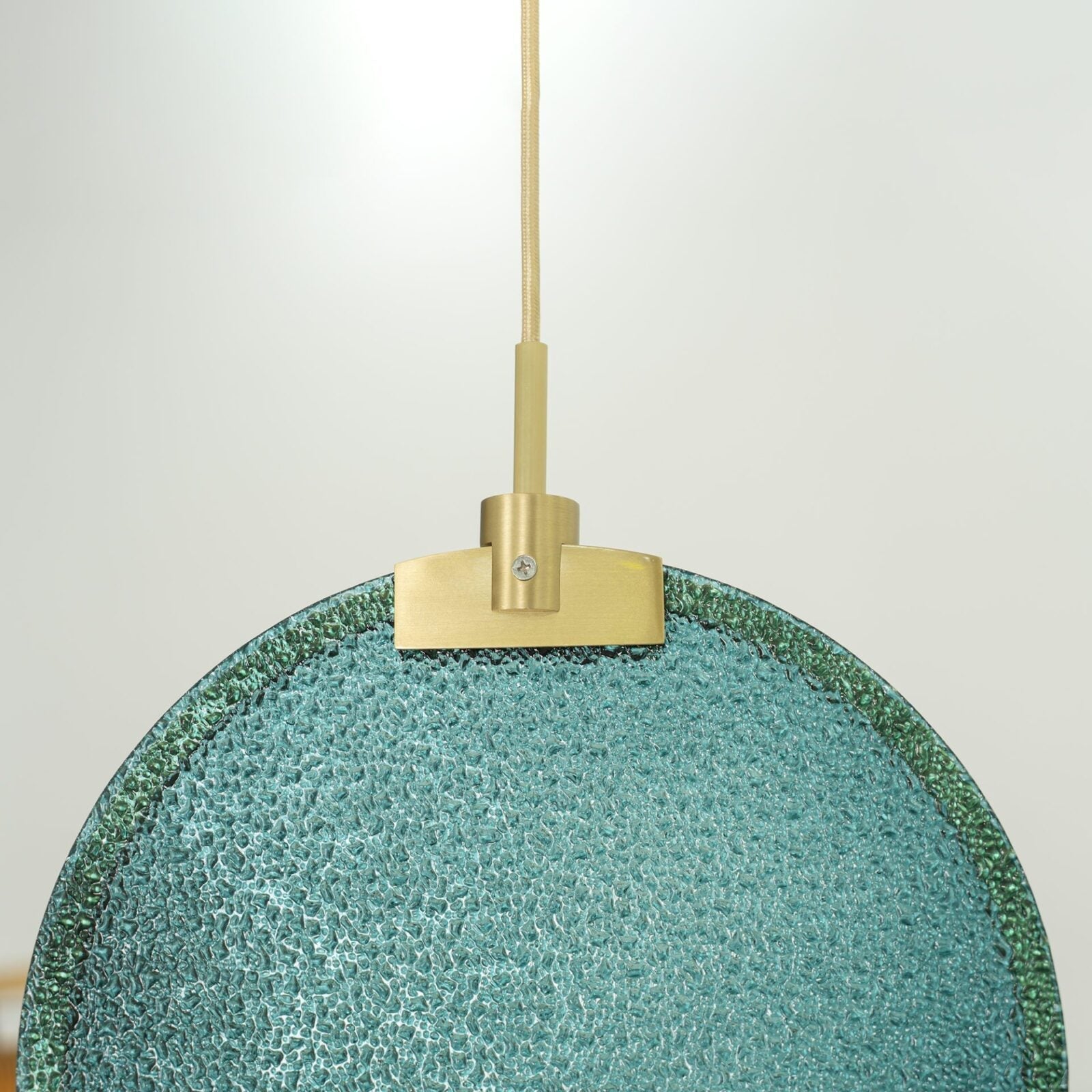 modern-circular-glass-pendant-light-with-brass-finish-and-integrated-led-spotlight