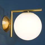 modern-opal-blown-glass-wall-sconce-with-elegant-brass-finish-round-globe-lighting