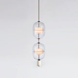 inder-nordic-glass-capsule-pendant-light-with-white-marble-and-metal-accents