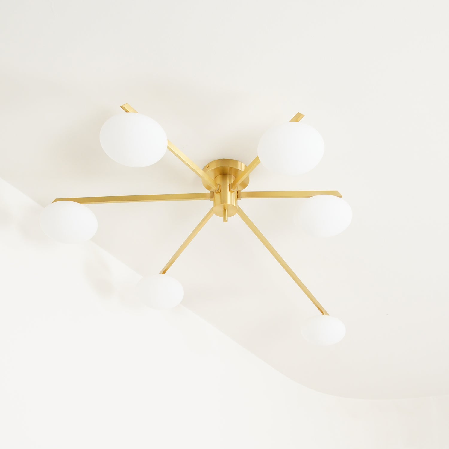 modern-jasper-glass-globe-ceiling-light-with-minimalist-metal-arms-and-oval-bulbs
