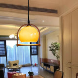 modern-vintage-glass-globe-pendant-lamp-with-adjustable-height-and-transparent-brown-shade
