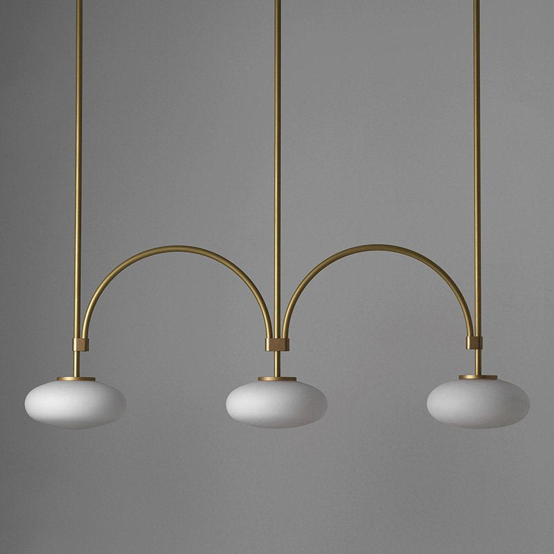 mid-century-modern-looping-brass-pendant-light-with-white-blown-glass-globes