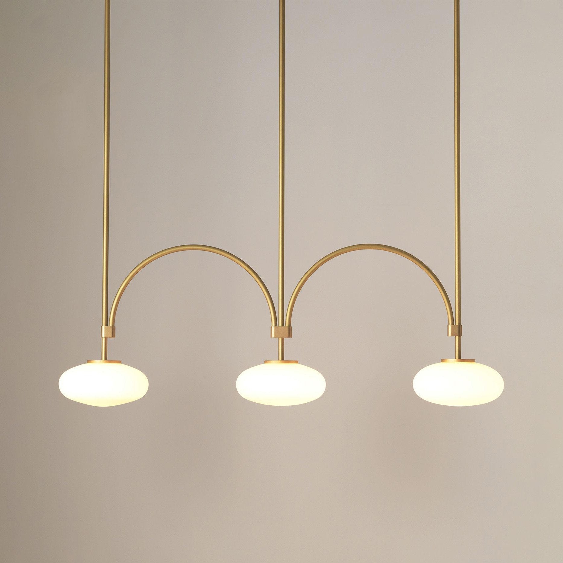 mid-century-modern-looping-brass-pendant-light-with-white-blown-glass-globes