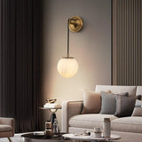 modern-alabaster-globe-wall-sconce-with-brass-accents-elegant-spherical-indoor-light