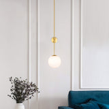modern-brass-and-opal-glass-sphere-mobile-wall-sconce-lighting-for-indoor-spaces