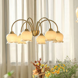 morup-elegant-floral-brass-and-resin-chandelier-with-shimmering-arches-and-cream-accents