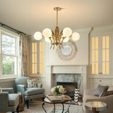 modern-ophelia-glass-globe-chandelier-with-wrought-iron-and-feather-detail-in-antique-gold