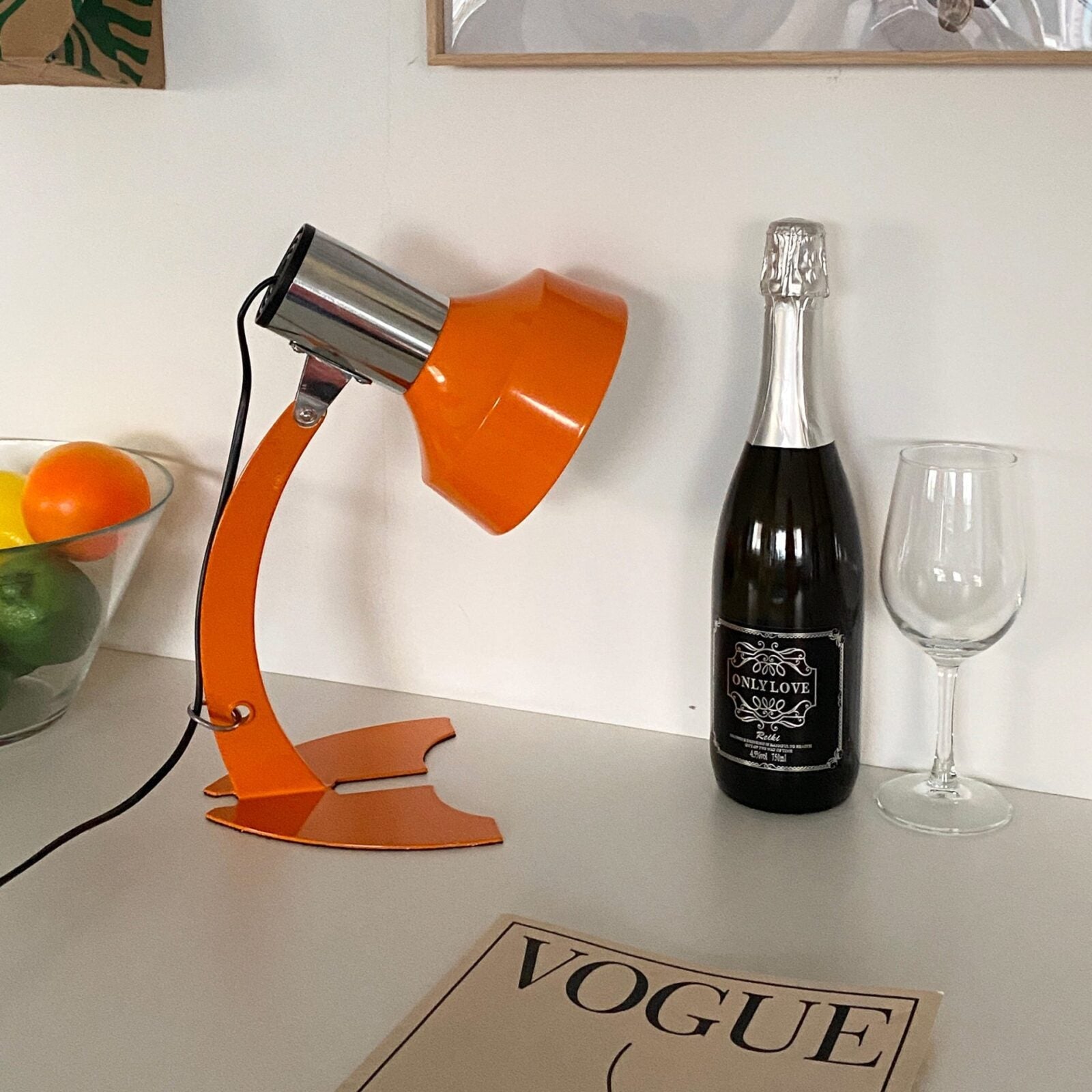 stylish-orange-and-chrome-metal-bedside-lamp-with-vibrant-apple-green-wire