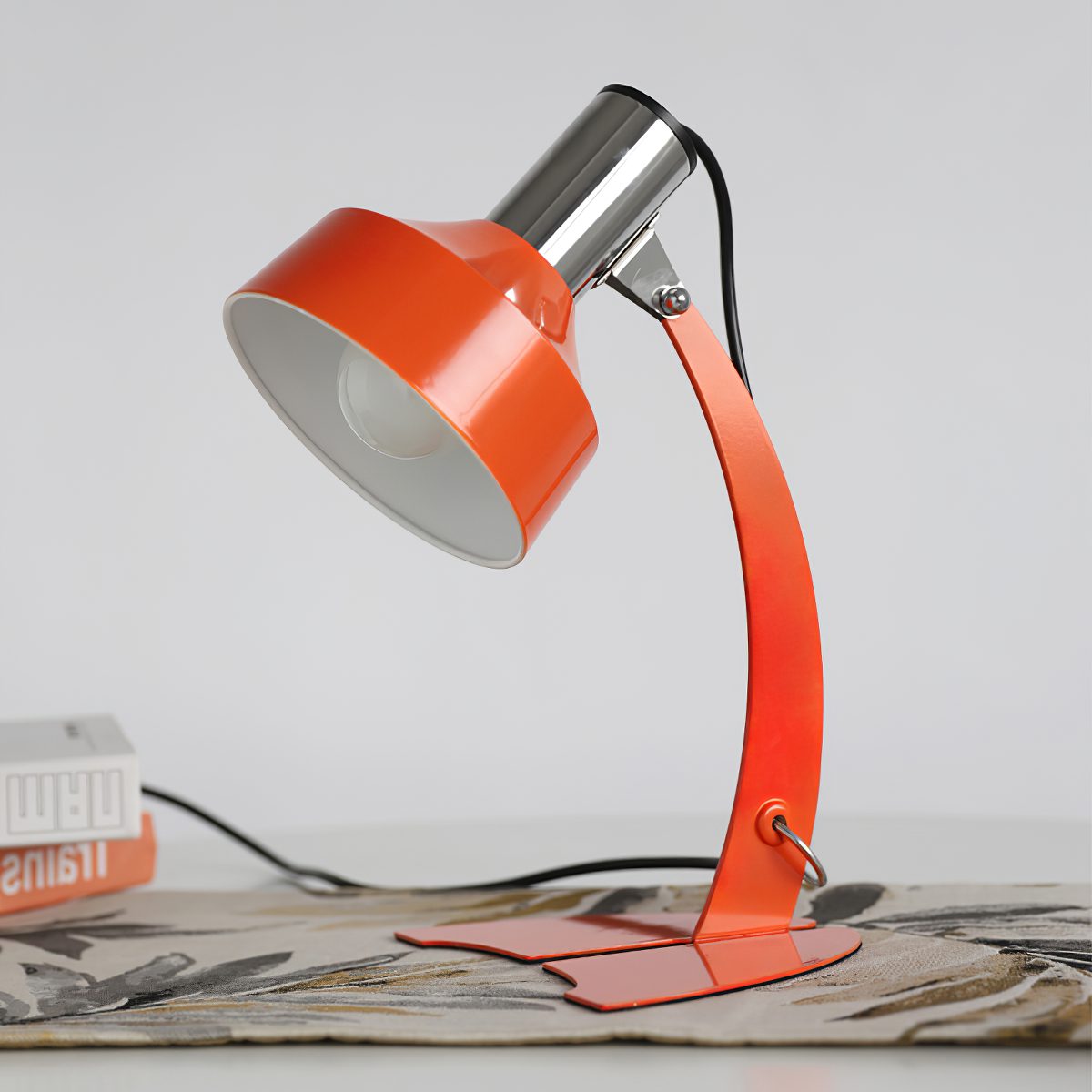 stylish-orange-and-chrome-metal-bedside-lamp-with-vibrant-apple-green-wire