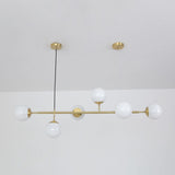 contemporary-multi-glass-globe-pendant-light-with-round-orb-shades-and-polished-brass-frame