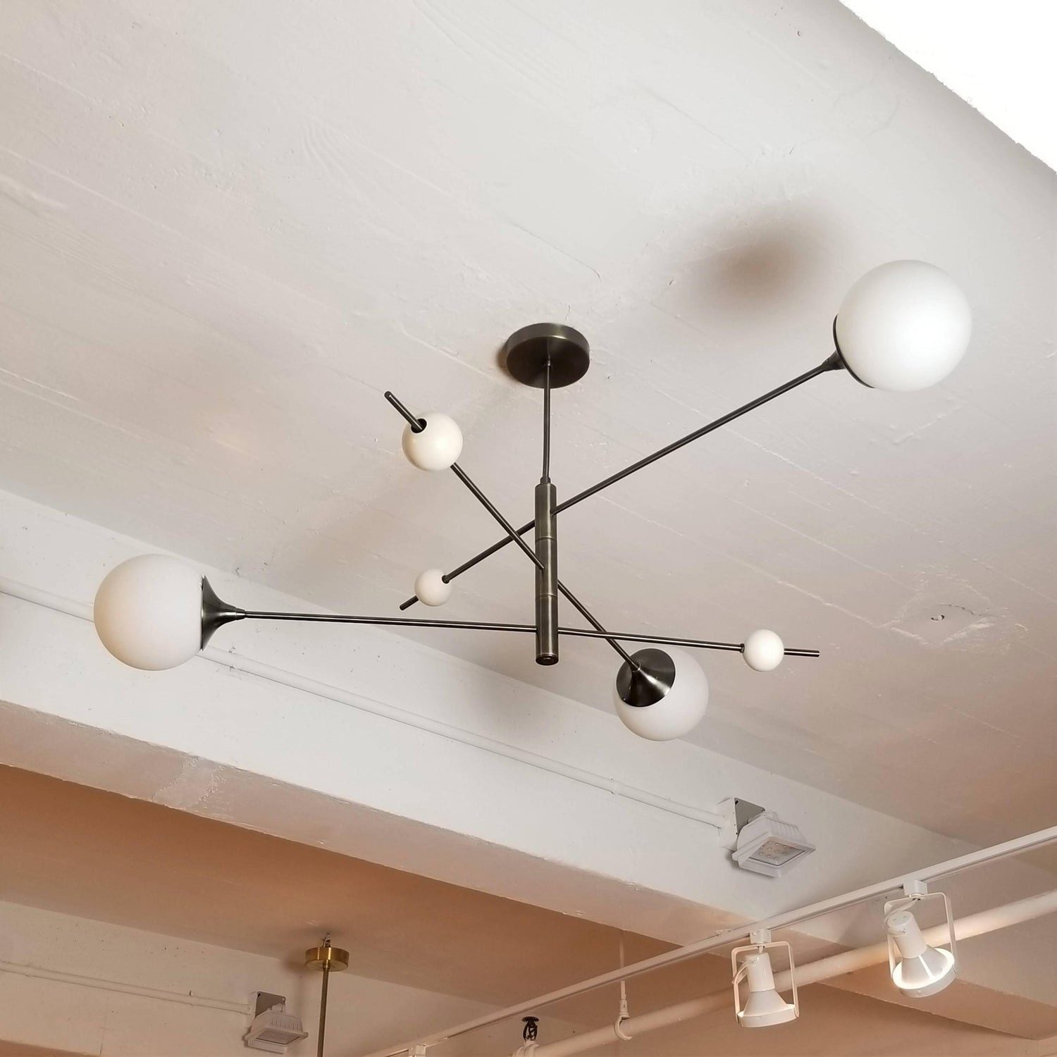 modern-orbital-3-arm-articulated-glass-globe-chandelier-in-copper-and-bronze-finish
