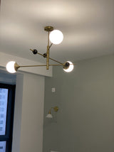 modern-orbital-3-arm-articulated-glass-globe-chandelier-in-copper-and-bronze-finish