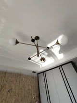 modern-orbital-3-arm-articulated-glass-globe-chandelier-in-copper-and-bronze-finish