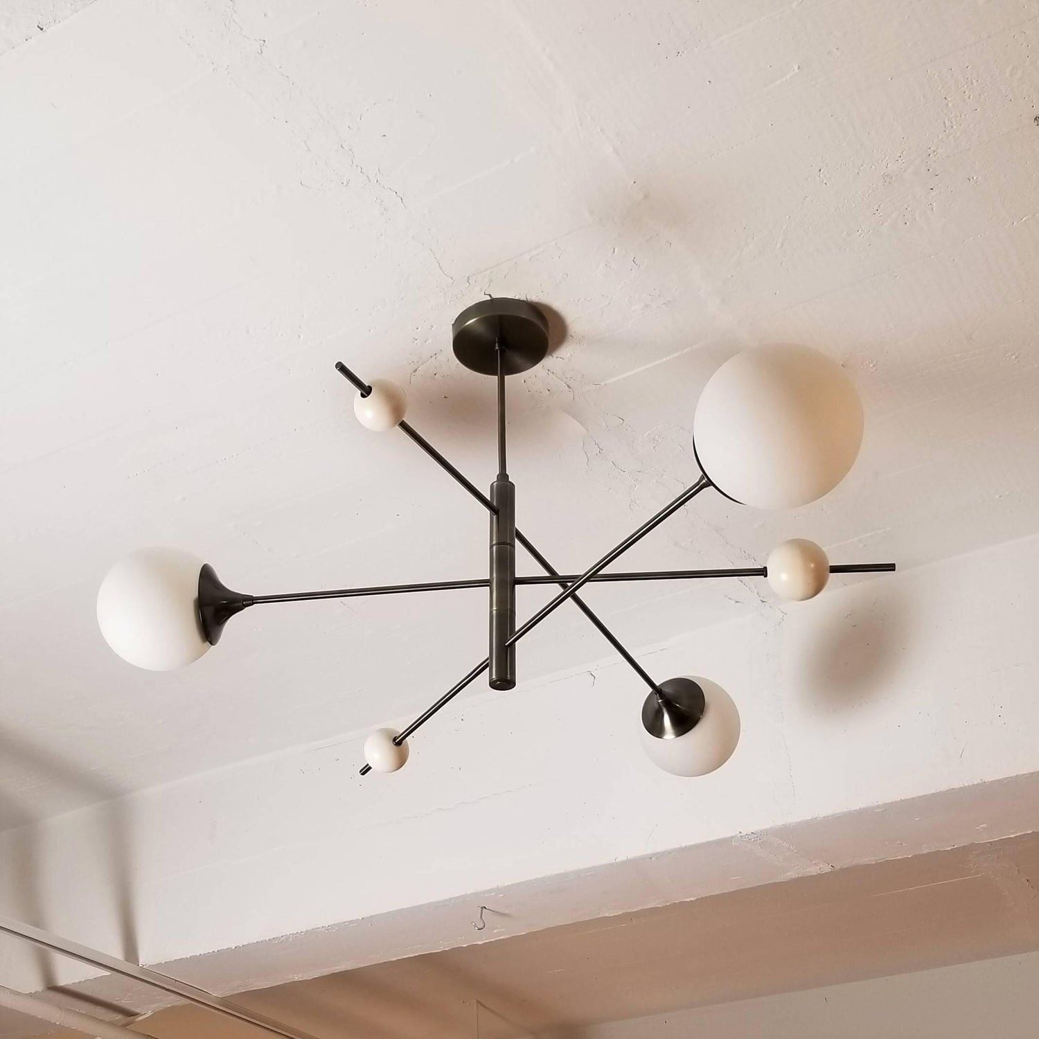 modern-orbital-3-arm-articulated-glass-globe-chandelier-in-copper-and-bronze-finish