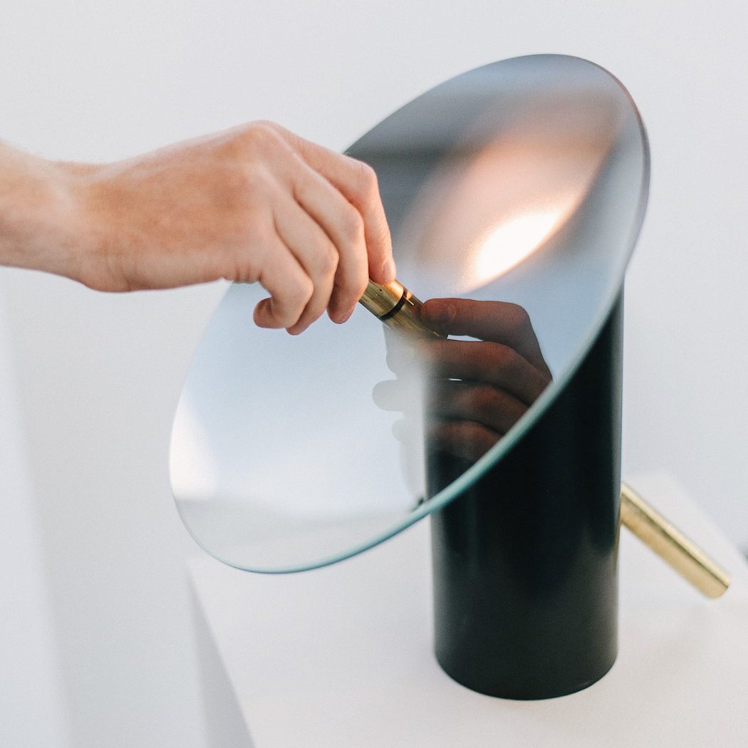 modern-interactive-glass-disc-table-lamp-with-rotating-brass-shaft-and-dimming-control