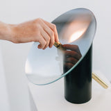 modern-interactive-glass-disc-table-lamp-with-rotating-brass-shaft-and-dimming-control