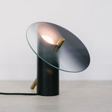 modern-interactive-glass-disc-table-lamp-with-rotating-brass-shaft-and-dimming-control