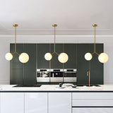 modern-asymmetric-glass-globe-pendant-light-with-brass-accents-and-hand-blown-glass