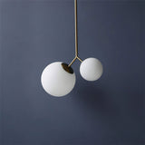 modern-asymmetric-glass-globe-pendant-light-with-brass-accents-and-hand-blown-glass