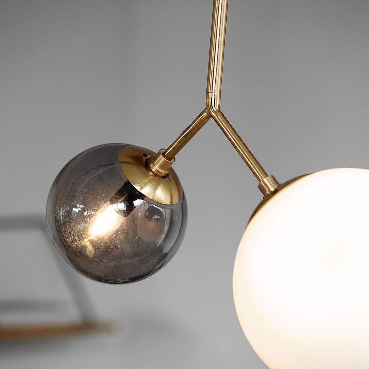modern-asymmetric-glass-globe-pendant-light-with-brass-accents-and-hand-blown-glass