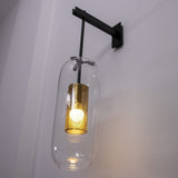 modern-vadim-glass-wall-sconce-with-perforated-metal-cage-and-brass-finish-for-luxury-interiors