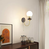 mid-century-walnut-wood-wall-sconce-lighting-with-white-glass-shade-and-pull-cord-switch