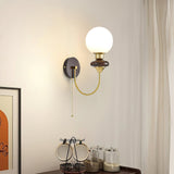 mid-century-walnut-wood-wall-sconce-lighting-with-white-glass-shade-and-pull-cord-switch
