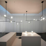 modern-minimalist-branch-chandelier-with-brass-bird-figures-and-white-glass-spheres